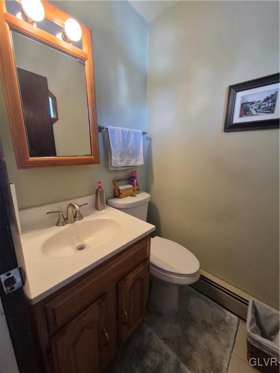 half bath featuring toilet, a baseboard radiator, vanity, and tile patterned floors