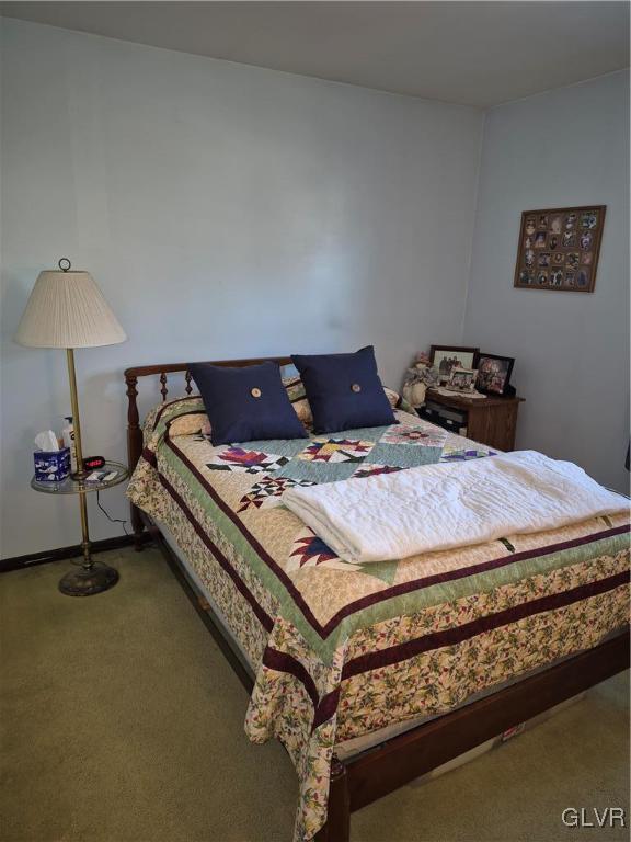 bedroom featuring carpet and baseboards