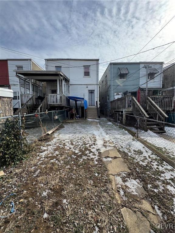 rear view of house with fence