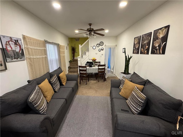 carpeted living area featuring stairs, a ceiling fan, and recessed lighting