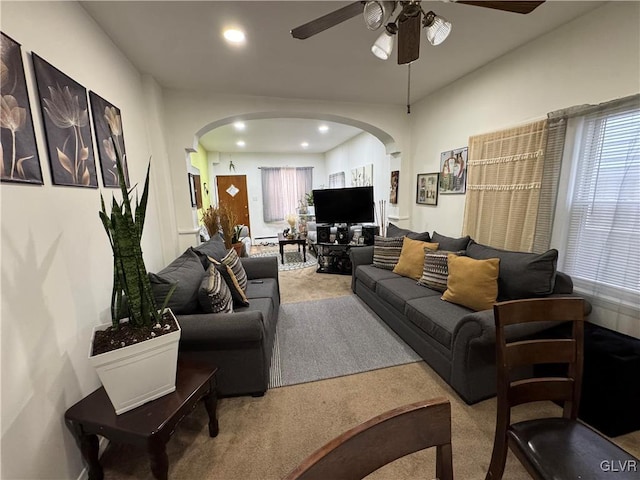 living room with carpet floors, arched walkways, and a wealth of natural light