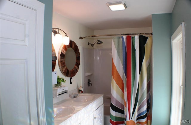 full bath with double vanity, a shower with curtain, visible vents, and a sink