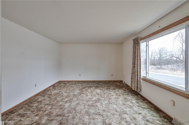 carpeted spare room with baseboards