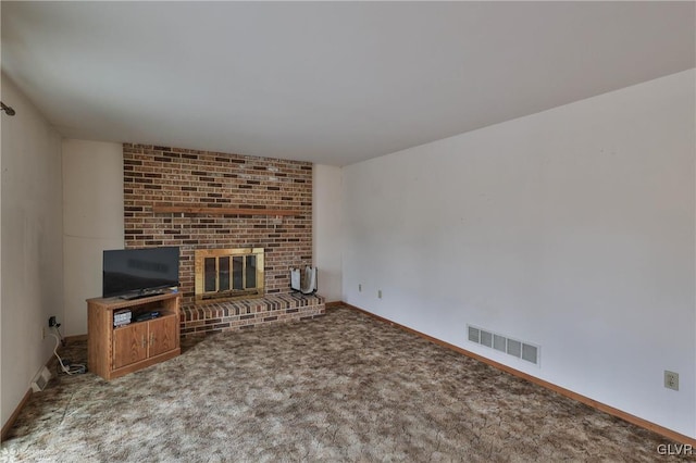 unfurnished living room with carpet floors, baseboards, a fireplace, and visible vents