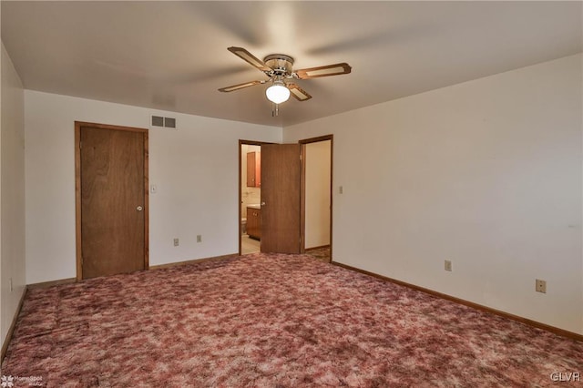 unfurnished bedroom with carpet, visible vents, connected bathroom, and baseboards