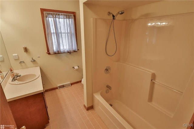 full bath with baseboards, visible vents, bathing tub / shower combination, toilet, and vanity