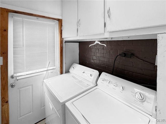 washroom featuring washing machine and clothes dryer and cabinet space