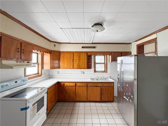 kitchen featuring stainless steel refrigerator with ice dispenser, light countertops, white electric range, a sink, and under cabinet range hood