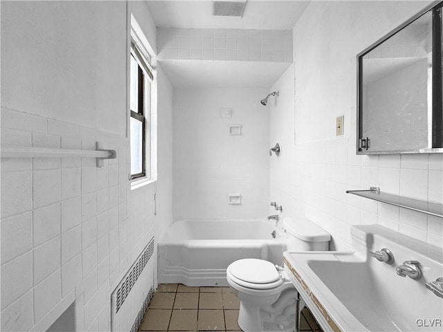 bathroom with visible vents, a sink, tile walls, and radiator