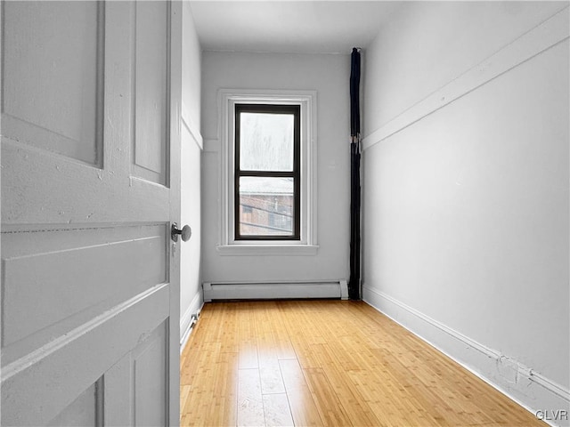 interior space with light wood-style floors, baseboards, and baseboard heating