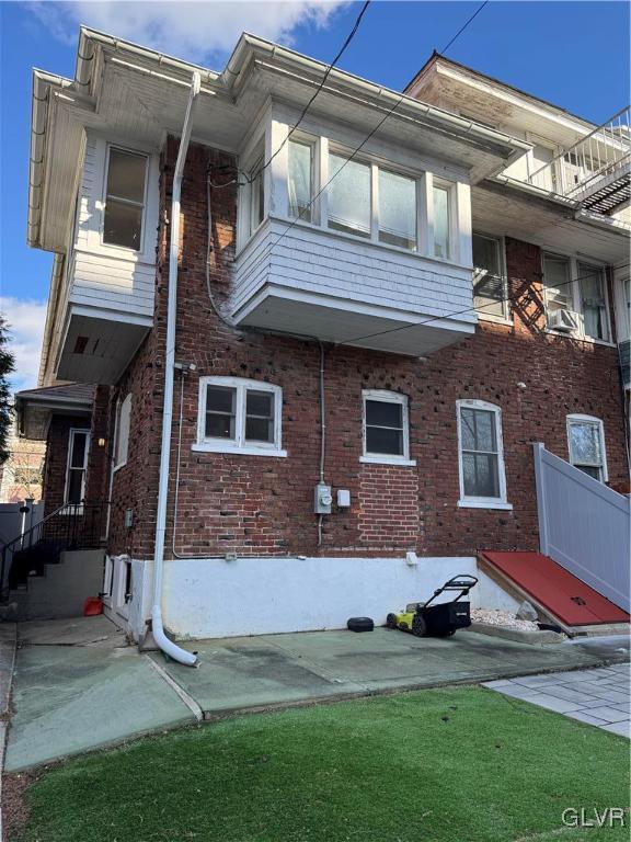 view of side of property featuring brick siding