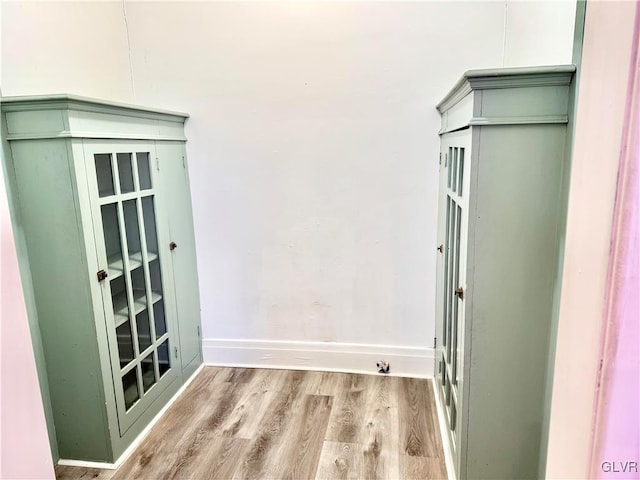 interior space with light wood-style floors and baseboards