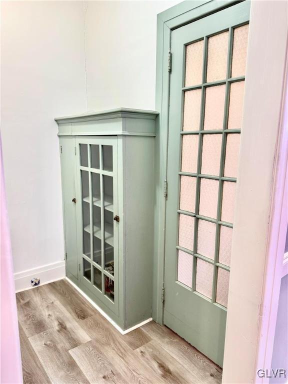 entryway with baseboards and light wood-style floors