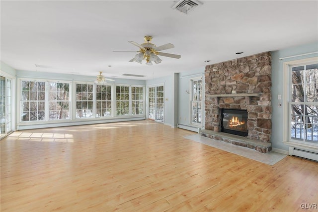 unfurnished living room with a fireplace, a baseboard radiator, visible vents, light wood-style floors, and ceiling fan