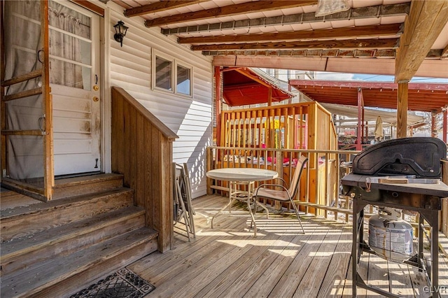 wooden deck featuring entry steps and a grill