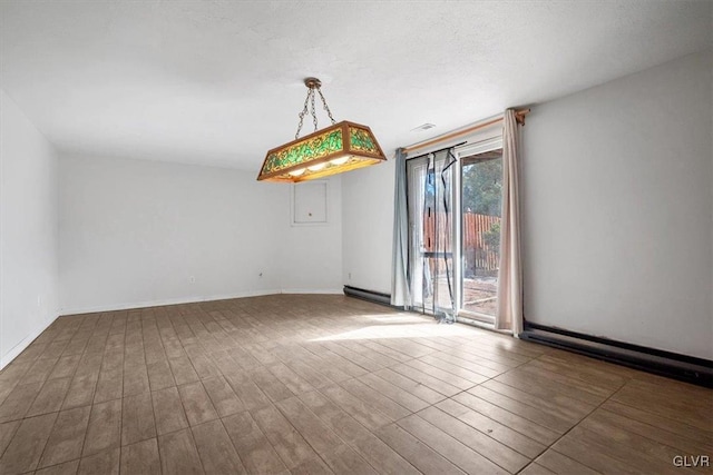 spare room featuring dark wood finished floors and baseboards