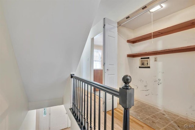 stairway with wood finished floors