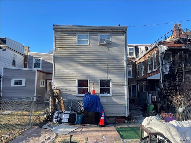 rear view of property with fence