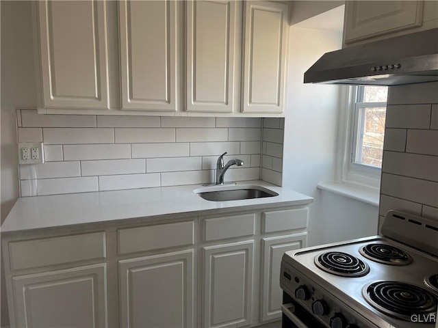 kitchen featuring a sink, white cabinets, white range with electric cooktop, and light countertops