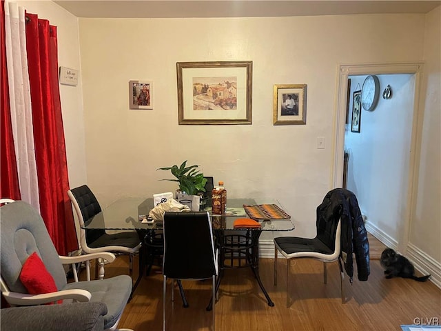 dining area featuring wood finished floors and baseboards