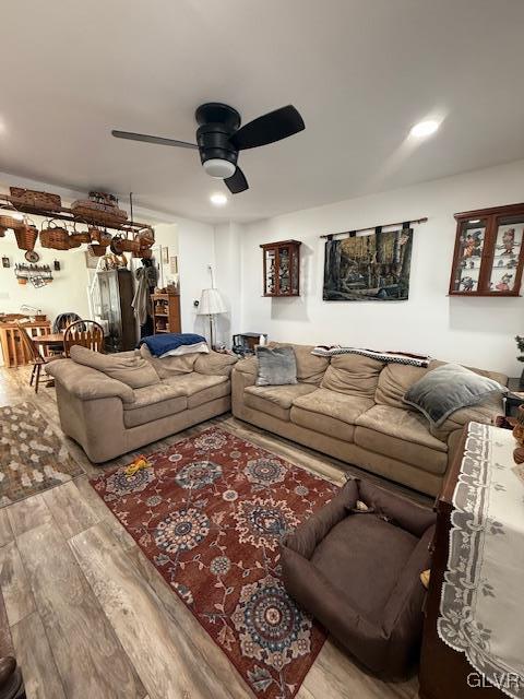 living room with ceiling fan and light wood-style flooring