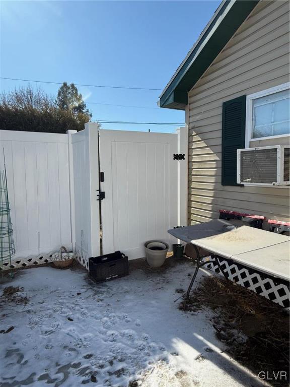 view of side of property with a gate and fence