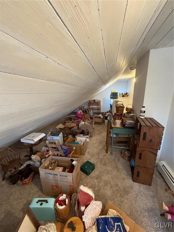 interior space with lofted ceiling, carpet floors, a baseboard radiator, and wood ceiling