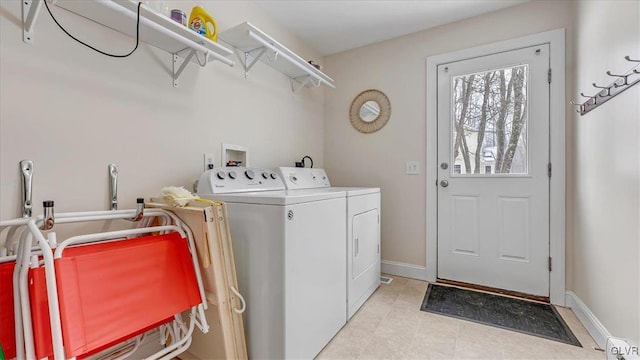 laundry area featuring washer and dryer, laundry area, and baseboards