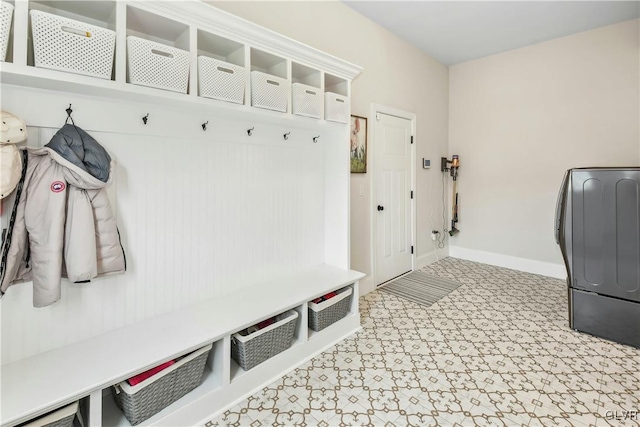 mudroom with washer / dryer, baseboards, and light floors