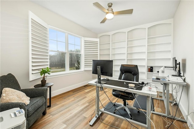 home office featuring ceiling fan, baseboards, and wood finished floors