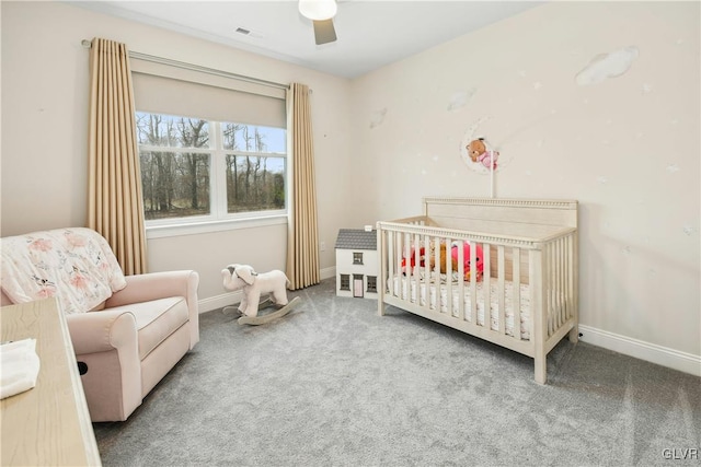 bedroom featuring a nursery area, carpet flooring, visible vents, and baseboards