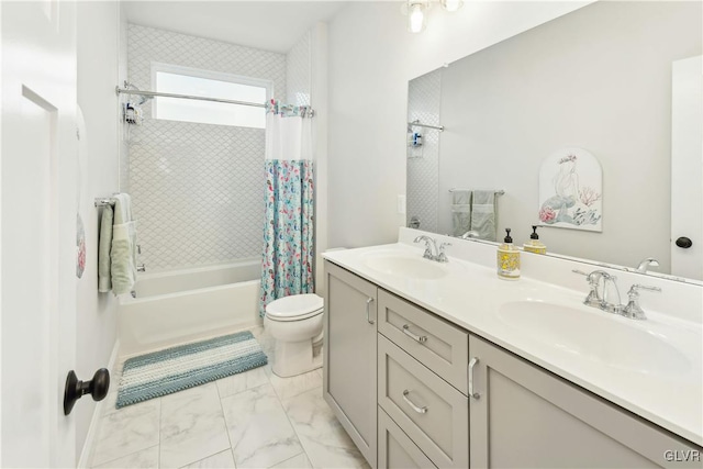 full bathroom featuring double vanity, marble finish floor, shower / bath combo, and a sink