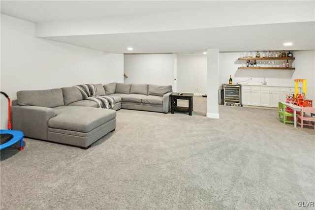 living room featuring light carpet, beverage cooler, wet bar, and recessed lighting