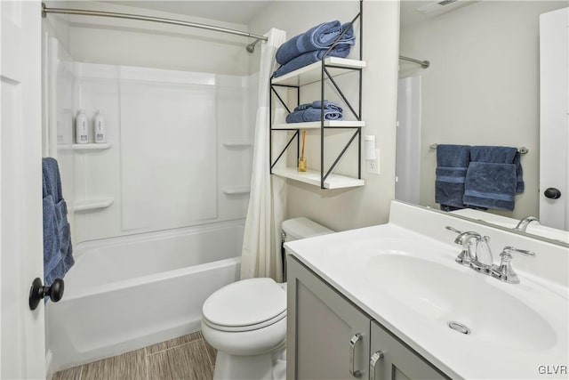 full bath featuring visible vents, vanity, shower / bath combo with shower curtain, and toilet