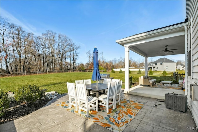 view of patio with ceiling fan, outdoor dining area, and a fenced backyard