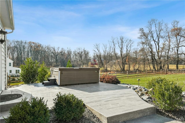 exterior space featuring a patio area, a hot tub, and fence