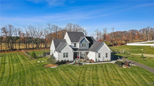 view of front of house featuring driveway and a front lawn