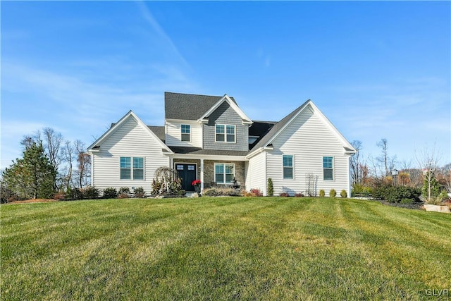 view of front of home featuring stone siding and a front lawn