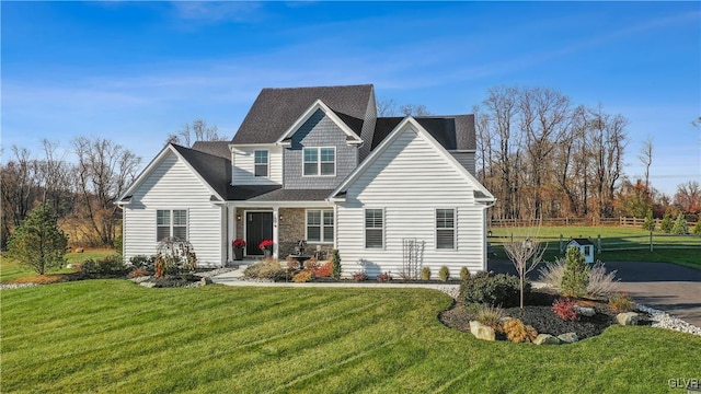 view of front facade featuring aphalt driveway and a front lawn