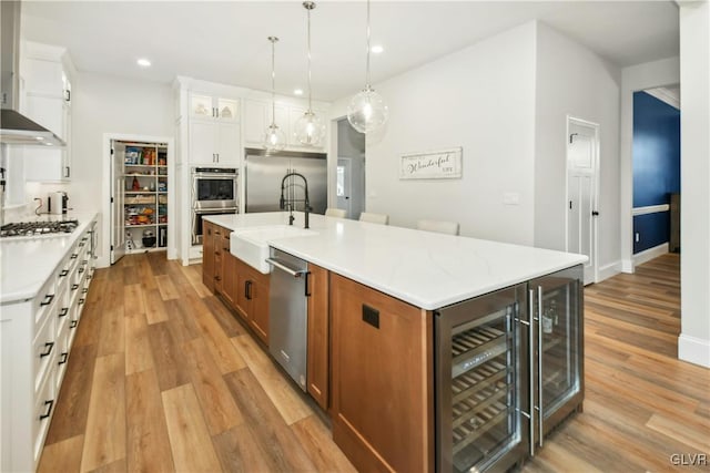 kitchen featuring brown cabinetry, a large island, and white cabinets