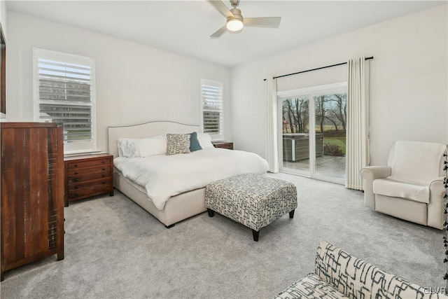 bedroom featuring light carpet, access to outside, and ceiling fan