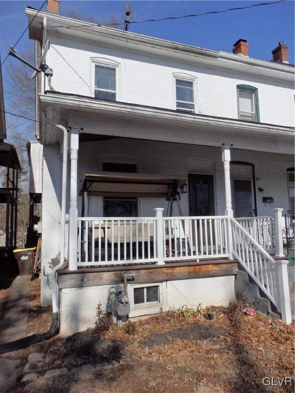 view of front of home with a porch and a chimney