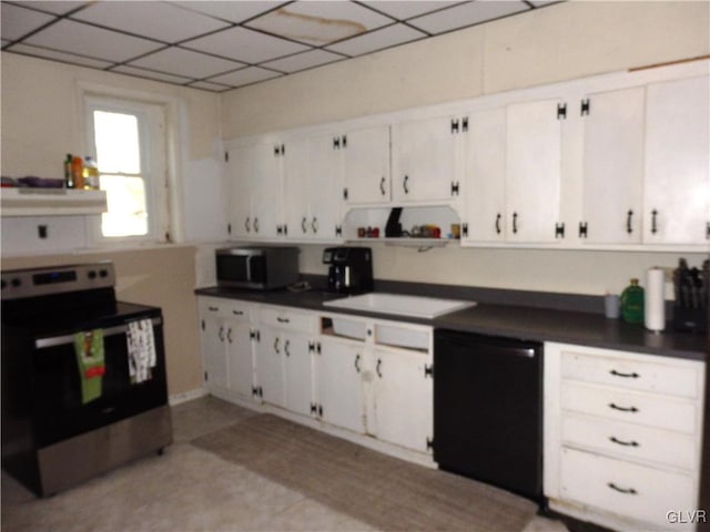 kitchen featuring dark countertops, a paneled ceiling, appliances with stainless steel finishes, white cabinets, and under cabinet range hood