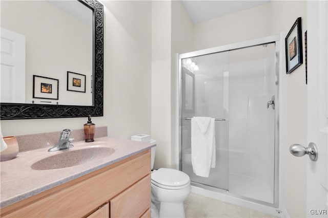 full bath featuring toilet, a stall shower, vanity, and tile patterned floors