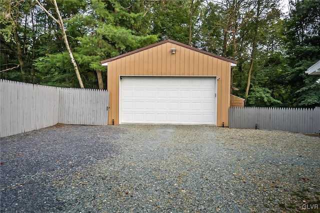 detached garage featuring fence