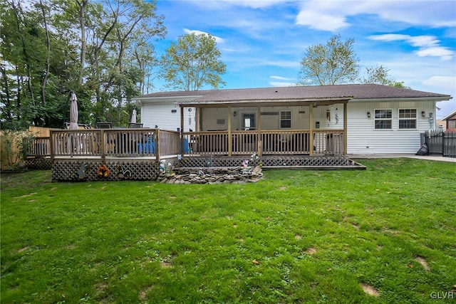 back of property featuring a yard and a wooden deck