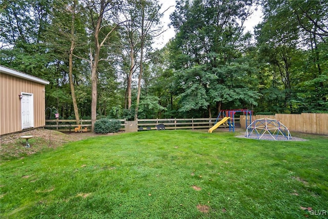 view of yard with a playground and a fenced backyard