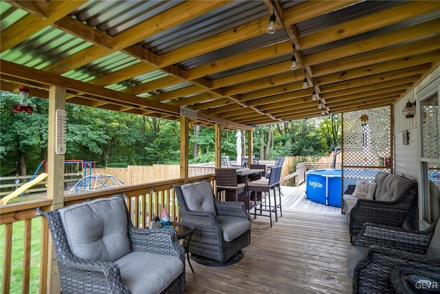 wooden terrace with fence, an outdoor hangout area, and a playground