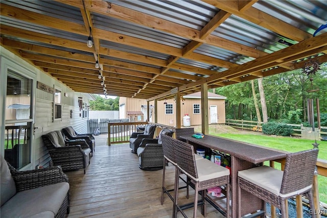 deck featuring fence, an outdoor hangout area, and an outbuilding