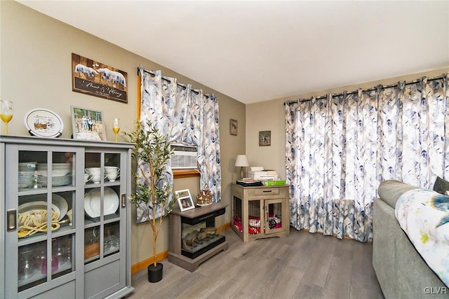 interior space with baseboards and wood finished floors